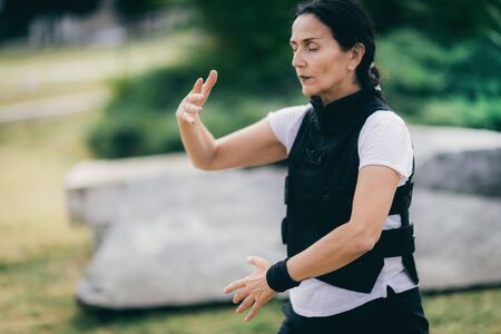 Woman practicing Qi Gong in the parkの写真素材