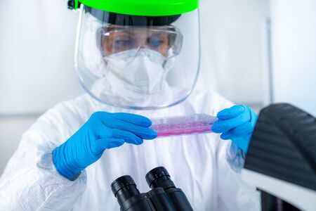 Coronavirus Vaccine Research. Scientist in Protective Suit Researching Virus Antibodies, Developing...