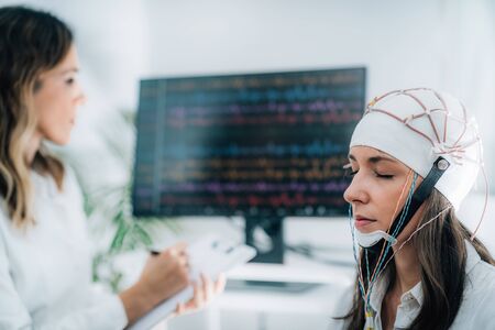 Female Patient in a Neurology Lab doing EEG Scanの写真素材