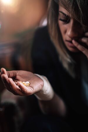 Psychiatric patient, woman with mental health problems, holding antidepressant pillsの写真素材