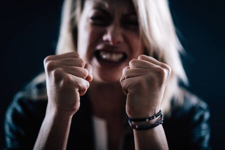Aggression â portrait of an angry aggressive woman with clenched fistsの写真素材