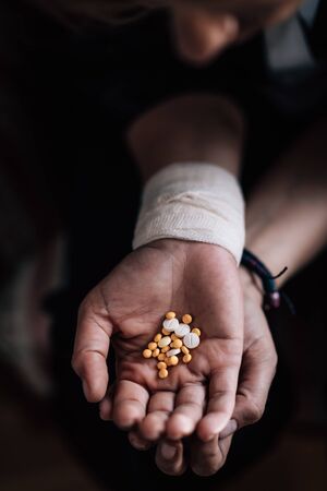 Mental Health Patient Holding a Bunch of Antidepressant Pills, Vertical Imageの写真素材
