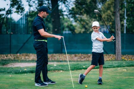 Golf â Personal Training. Golf Instructor Teaching Young Boy How to Play Golf. の写真素材
