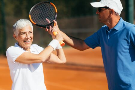 Active Senior Woman Practicing Tennisの写真素材