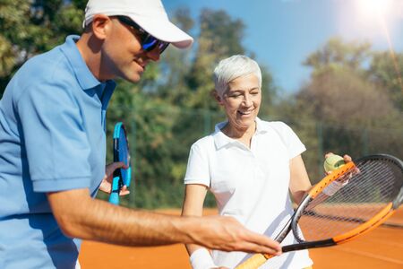 Mature Woman Playing Tennisの写真素材