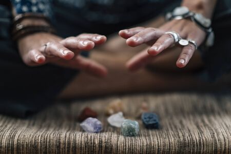 Meditation Practice with the healing energy of crystals. Female hand, close up.