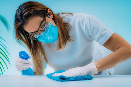 Surface Disinfection. Woman Disinfecting Table Surfaceの写真素材