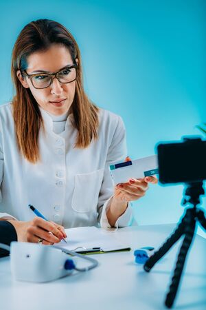 Telemedicine â€“ Medical doctor having a virtual conference session with patient and showing...