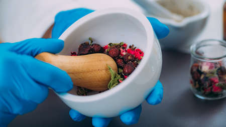 Grinding Herbs and Flowers Using Mortar and Pestleの写真素材