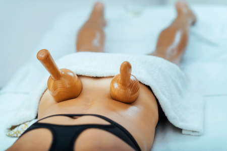 Maderotherapy anti cellulite massage treatment with wooden vacuum cupの写真素材