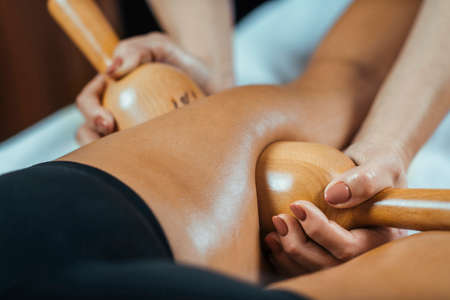 Maderotherapy anti cellulite massage treatment with wooden vacuum cup