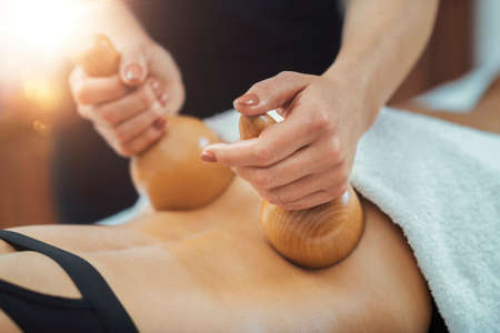 Maderotherapy anti cellulite massage treatment with wooden vacuum cup