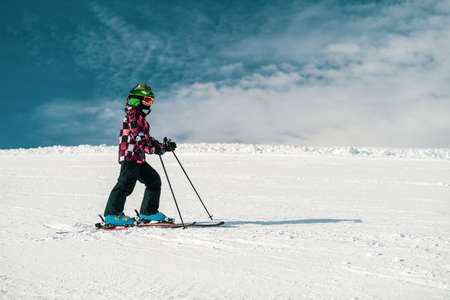 Cute Child Skiing Down the Slopeの写真素材