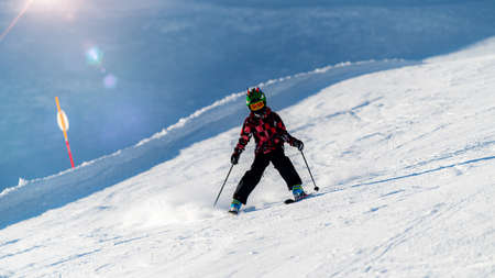 Cute Child Skiing Down the Slopeの写真素材