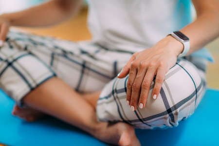 Relaxed Woman Meditating at Home. Measuring HR with Smart Watch.の写真素材