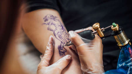 Tattooing process in a tattoo studioの写真素材