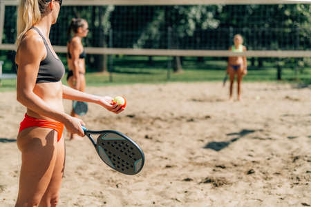 Female Friends Playing Beach Tennisの写真素材
