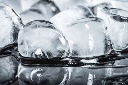 Ice cubes on a black reflective backgroundの写真素材