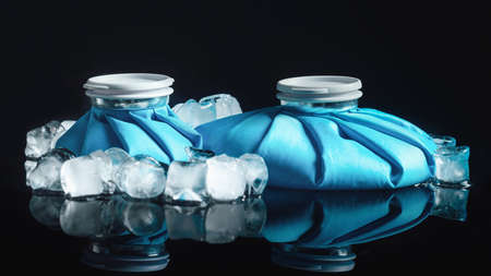 Cold Therapy. Reusable blue ice bags for cold therapy, isolated on black reflective backgroundの写真素材