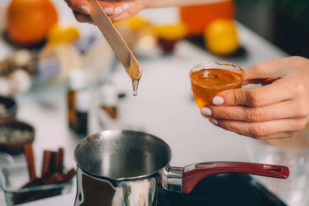 Woman Making Homemade Soap with Honeyの写真素材