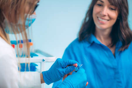 Finger Prick Blood Draw. Nurse Taking Blood Sample from Patientâs Fingerの写真素材