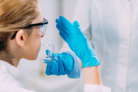 Scientists examining the smell of a substance. Olfaction laboratory test.