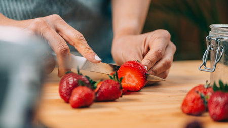 Fruit preservation at home. Woman preparing fruits for canning at home.の写真素材