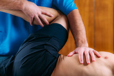 Discus Hernia manual massage treatment. Physical therapist massaging lower back.の写真素材
