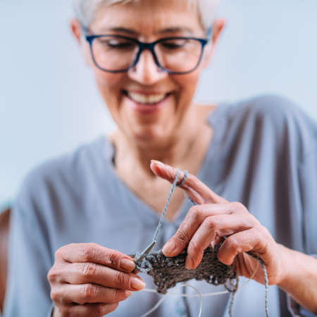 Senior Woman Knitting. The activity known to support the preservation of cognitive abilities