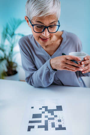 Crosswords. Cognitive rehabilitation therapy for senior women.の写真素材