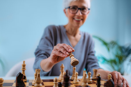 Senior woman playing chess. Cognitive rehabilitation therapy.の写真素材