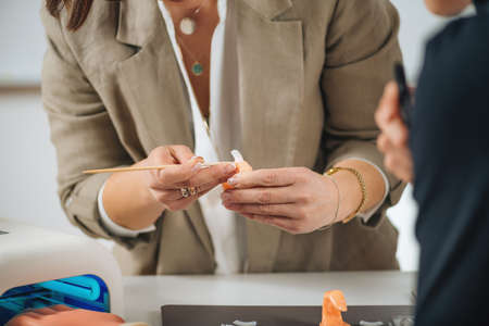 Cosmetology education - program for manicurists and cosmetologists.  Beautician practicing for nail...