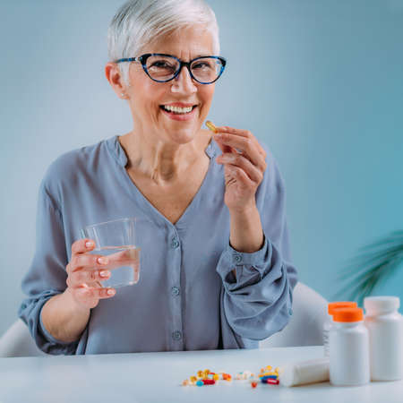 Senior Woman Taking Omega 3 EPA DHA Supplementsの写真素材