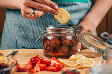 Fermentation food at home. Woman preparing fruits for fermentation.の写真素材