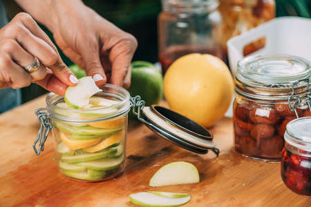 Fermentation food at home. Woman preparing fruits for fermentation.の写真素材