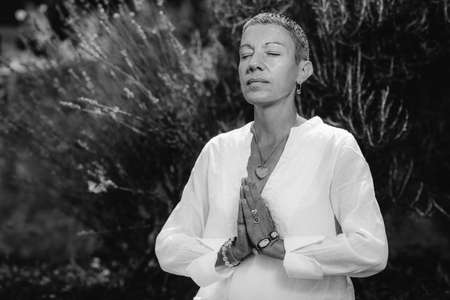 Female hands in prayer position outdoor. Self-care practice for wellbeingの写真素材