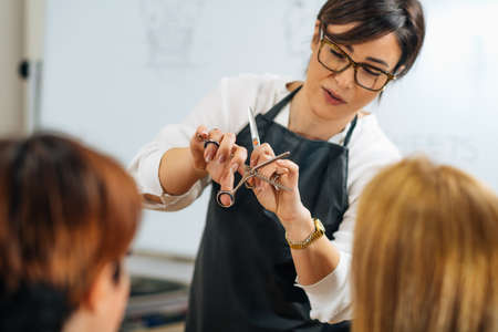Haircutting training and education program in hair salon with mannequin headの写真素材