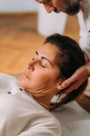 Therapist stretching womanâs neck. Shiatsu massage.の写真素材