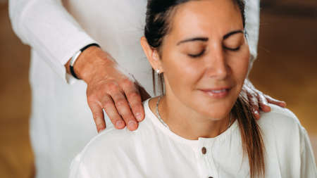 Woman enjoying shiatsu neck and shoulders massage.の写真素材