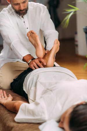 Therapist Stretching womanâs legs. Shiatsu massage.の写真素材