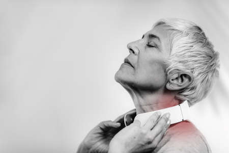 Senior Woman Wearing Pulse Neck Massagerの写真素材