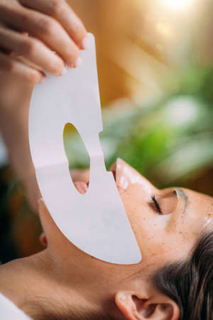 Woman with Skincare Face Mask in Beauty Salonの写真素材