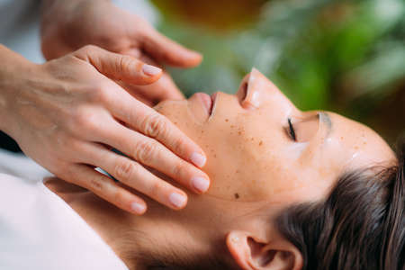 Woman with Skincare Face Mask in Beauty Salonの写真素材