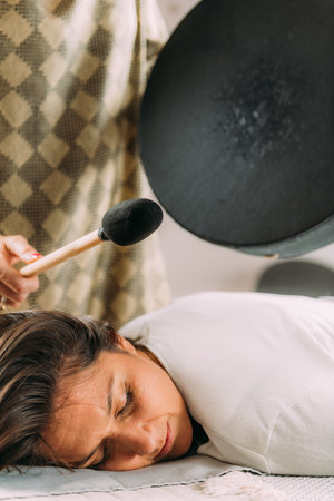 Playing moon drum in a sound healing therapy sessionの写真素材