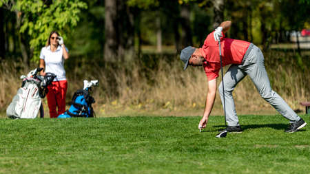 Couple on a golfing vacation, beautiful sunny weatherの写真素材
