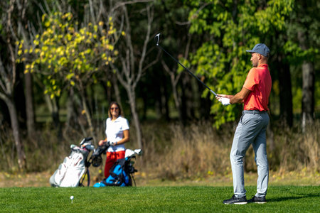 Couple on a golfing vacation, beautiful sunny weatherの写真素材