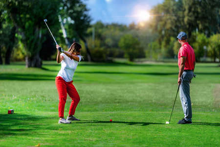 Golf vacation for couples, playing golf in a beautiful sunny weatherの写真素材