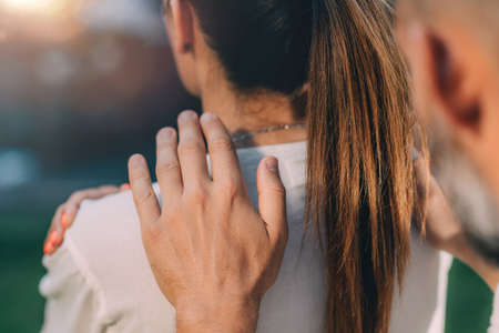 Reiki Lesson. Reiki instructor with hands over shoulders of the course attendee, transferring energy.の写真素材