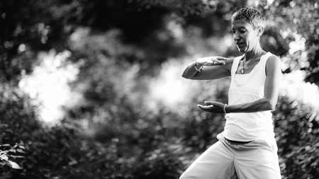 Energy work and mindfulness practice. Young woman doing energy work in a forestの写真素材