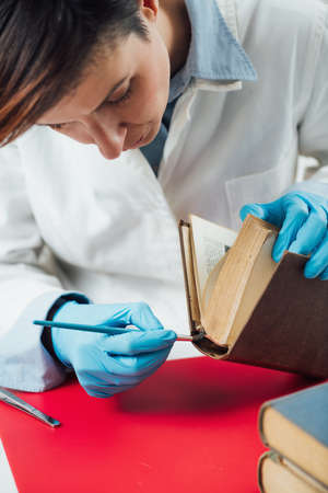 Book restoration and rebinding professional at work